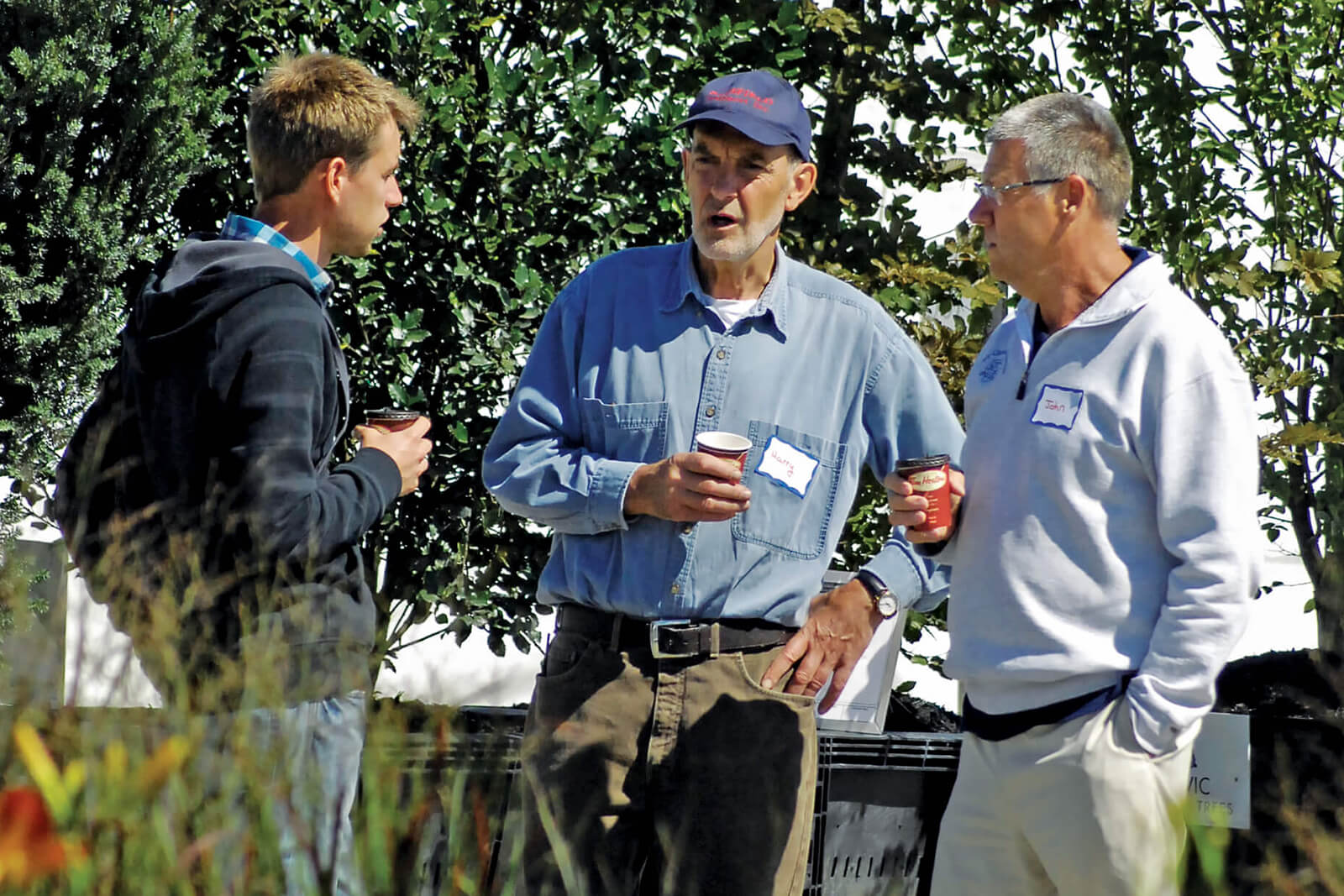 three nursery growers talking