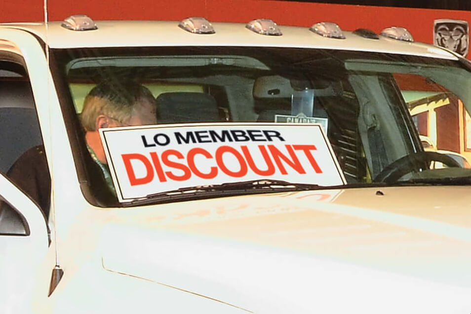 new white RAM 3500  truck for sale with LO member discount sign in front window