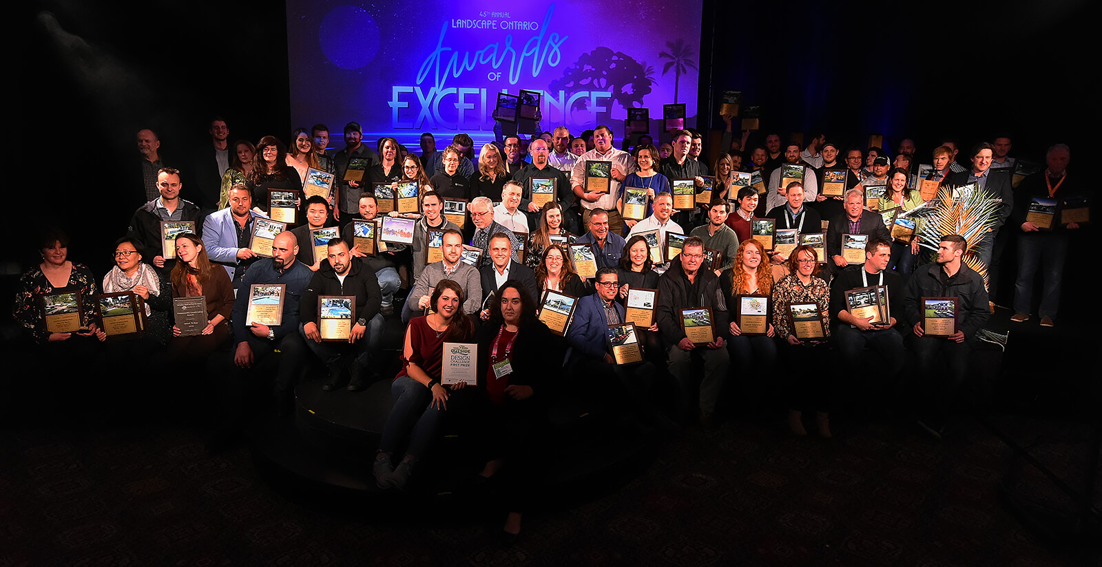 large group of award winners on stage