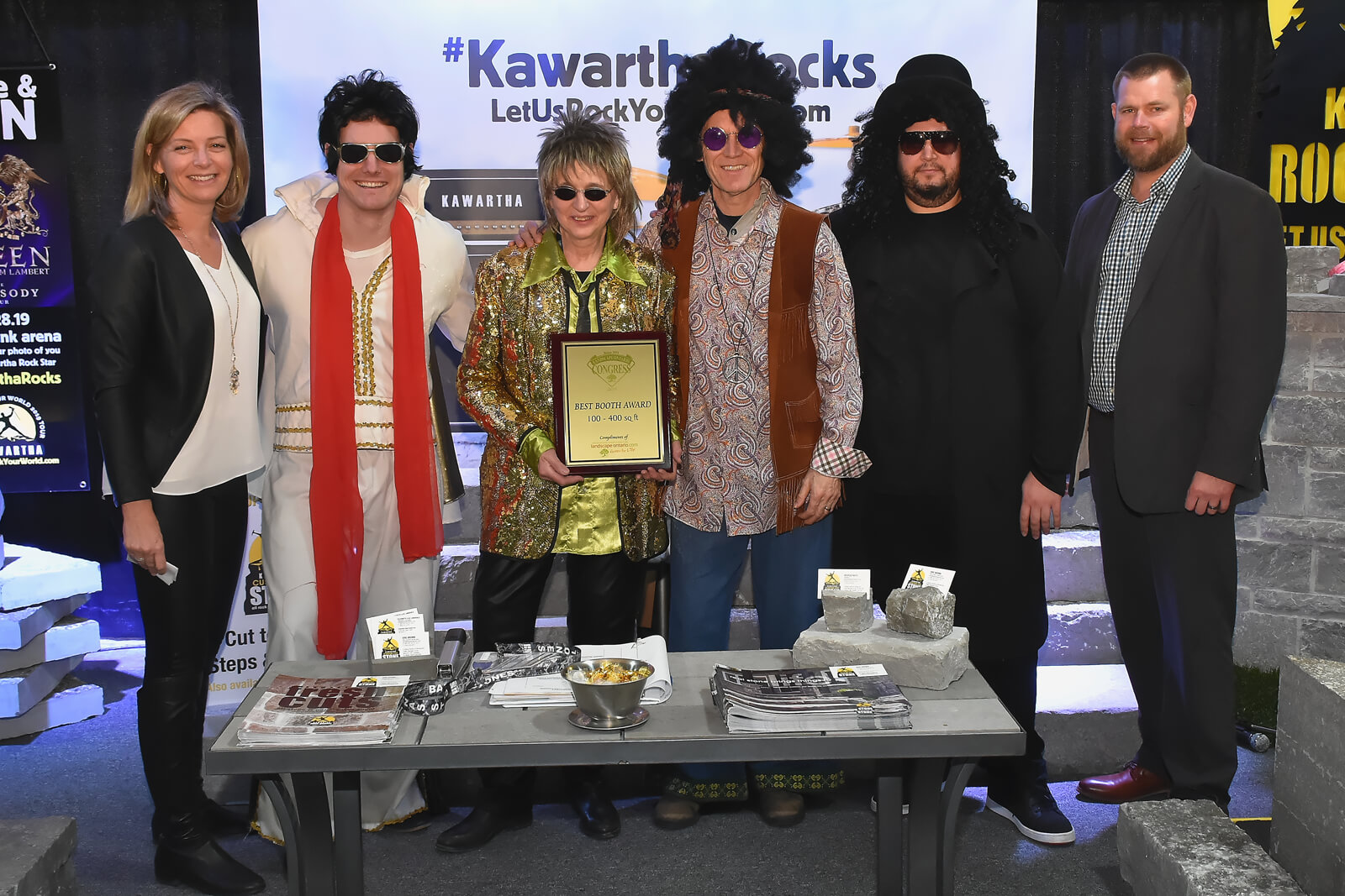 booth winners holding plaque