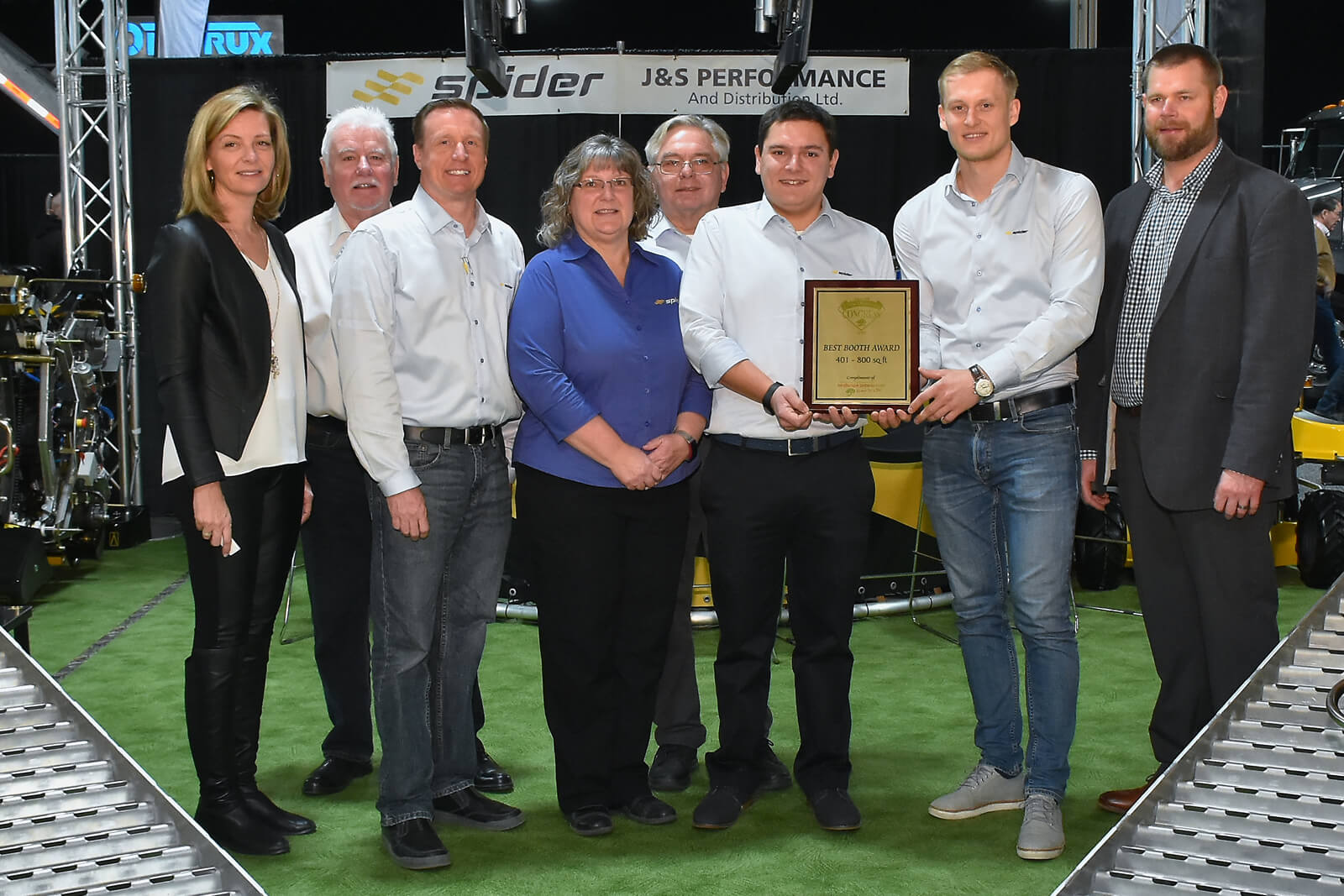 booth winners holding plaque