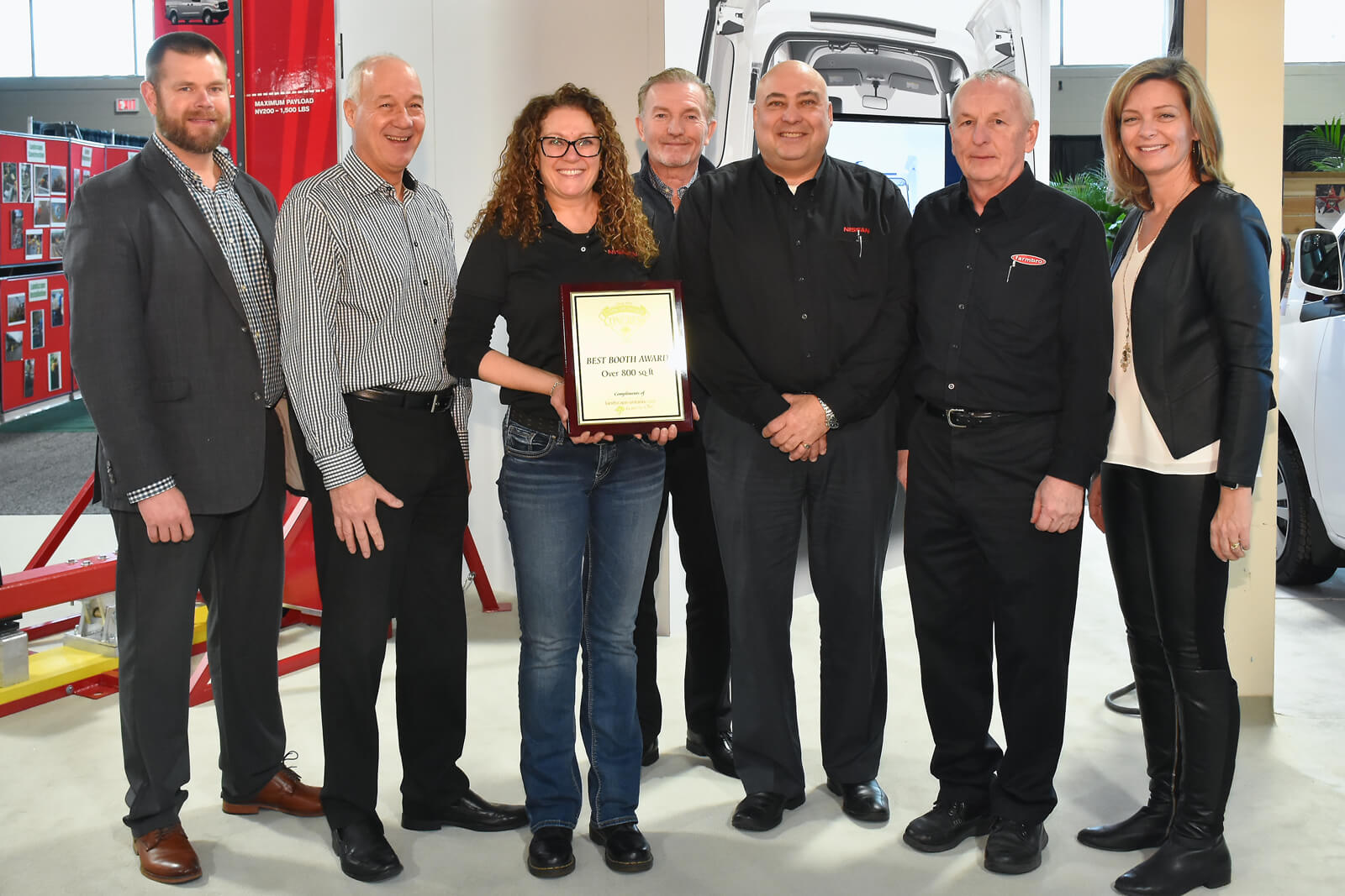 booth winners holding plaque