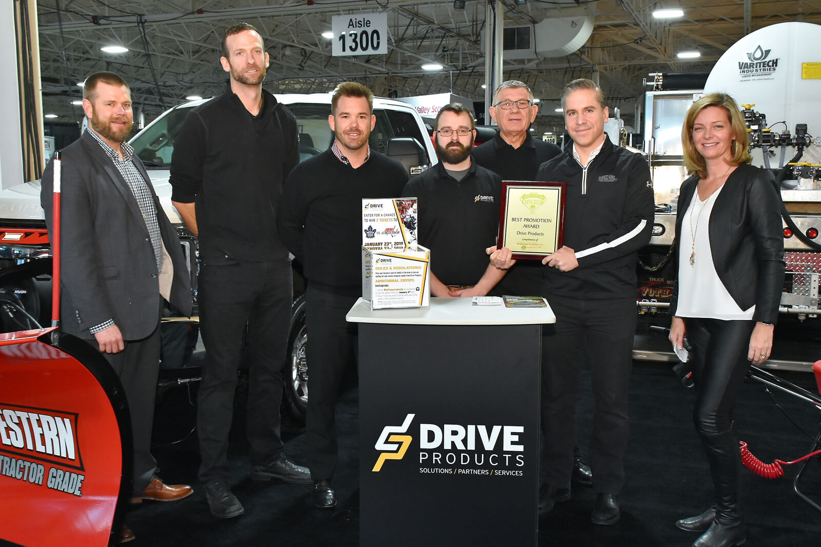 booth winners holding plaque