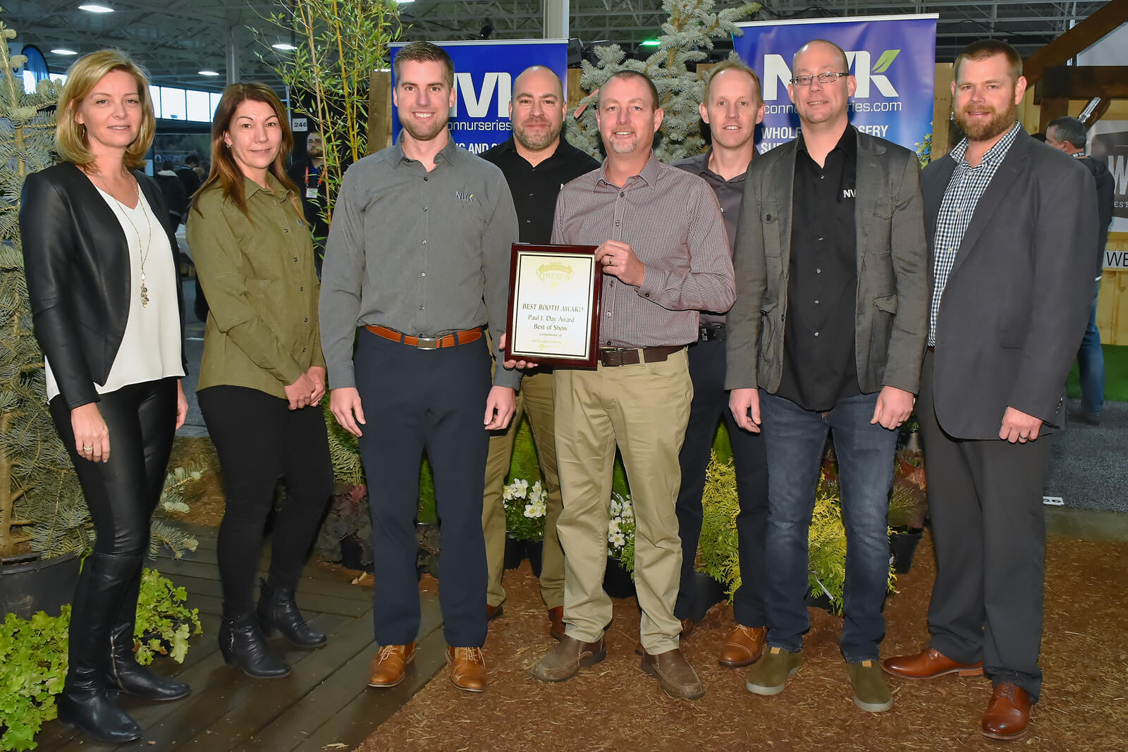 booth winners holding plaque