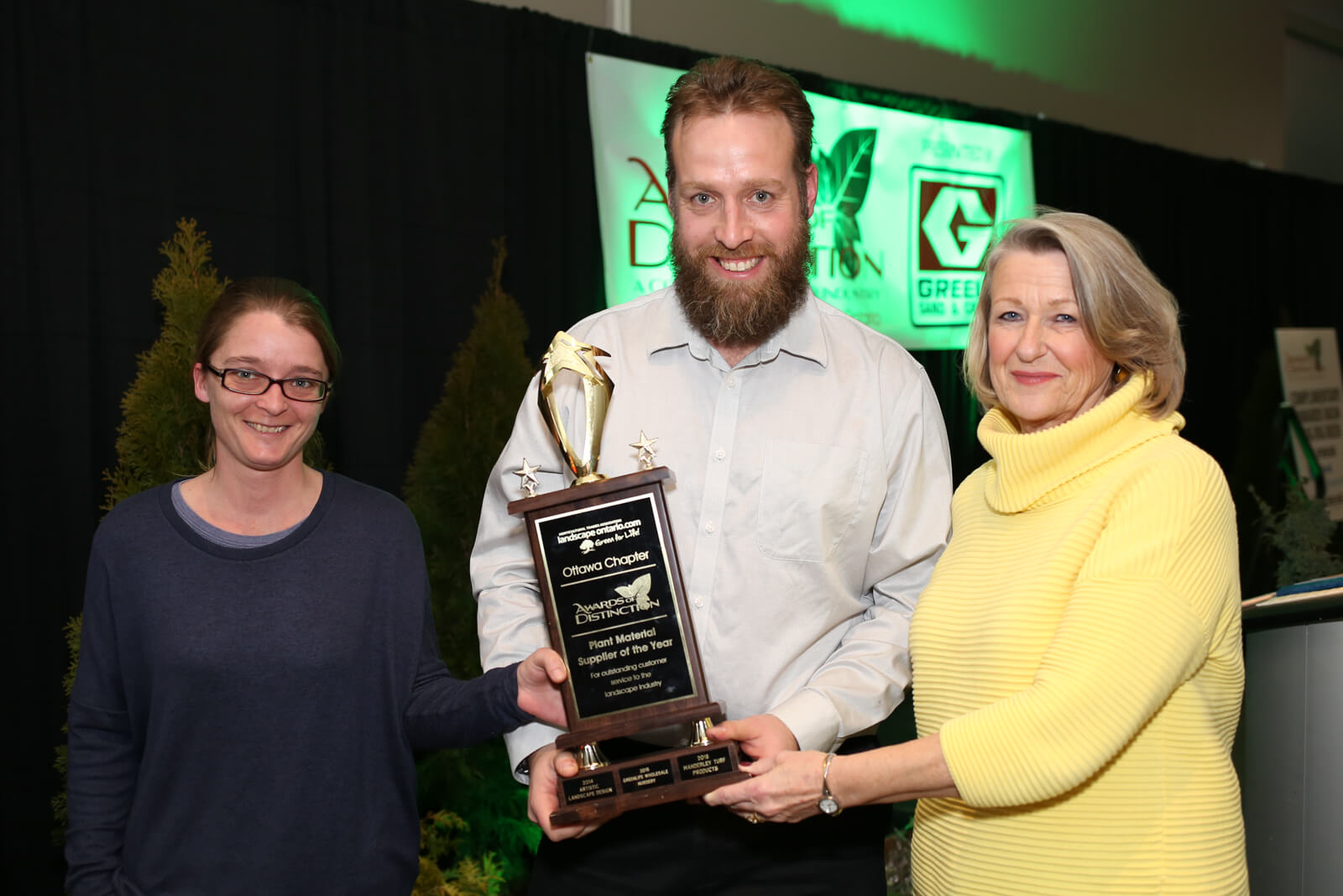 three people accepting an award