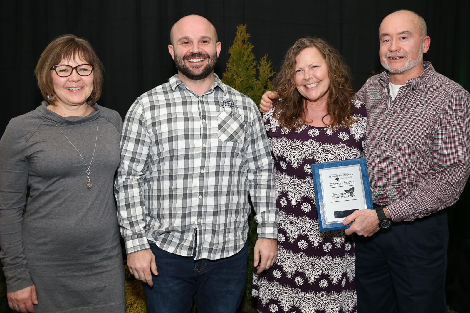 three people accepting an award