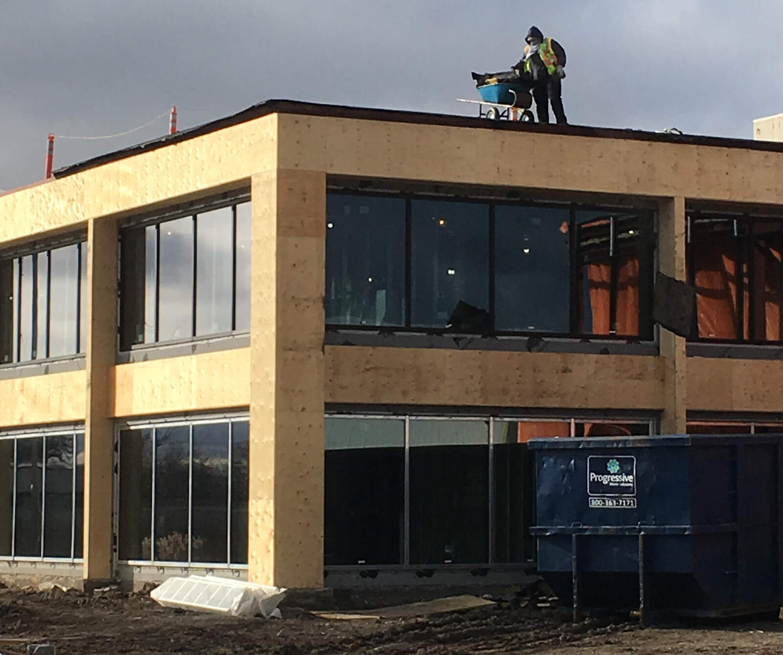 worker on roof of building under renovation