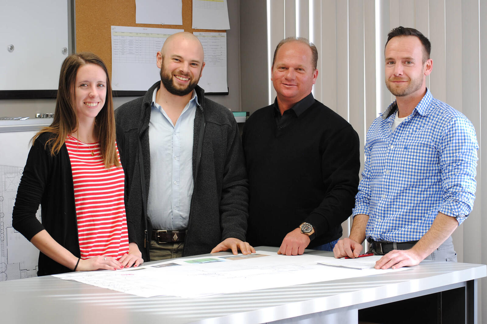 four co-wokers gathered at a table