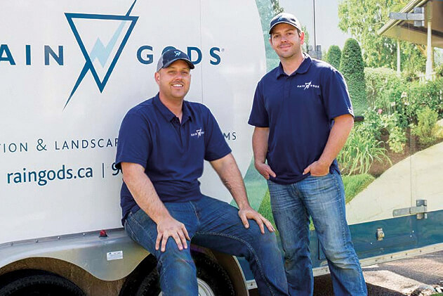 tow men in front of a work trailer