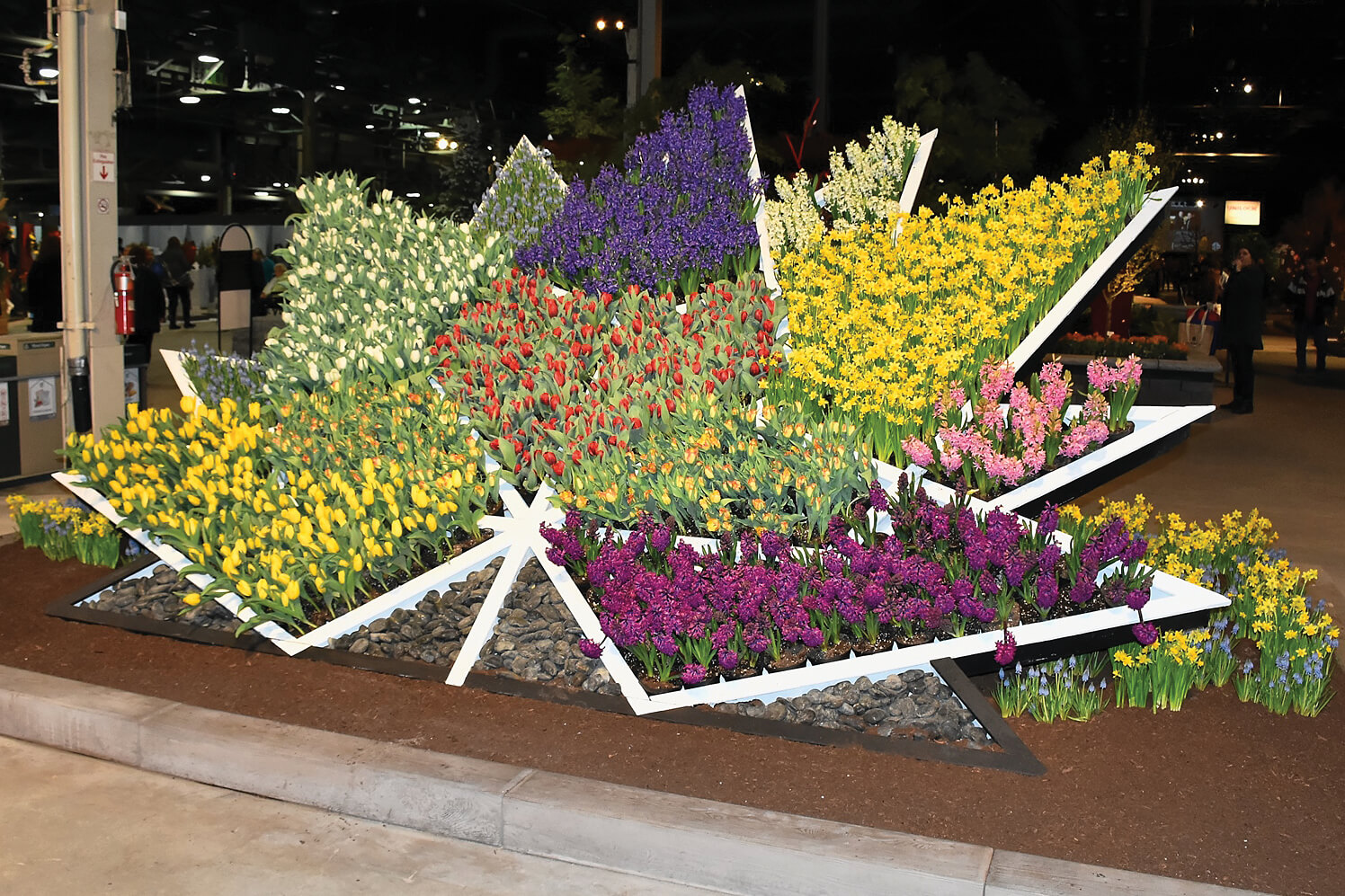 interlocking stone with a red maple leaf pattern and 150 in the centre