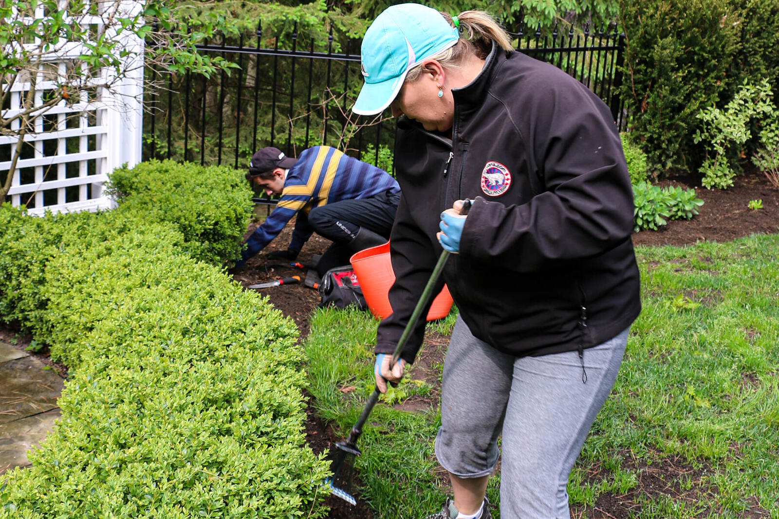 woman working with a hand tool in the garden
