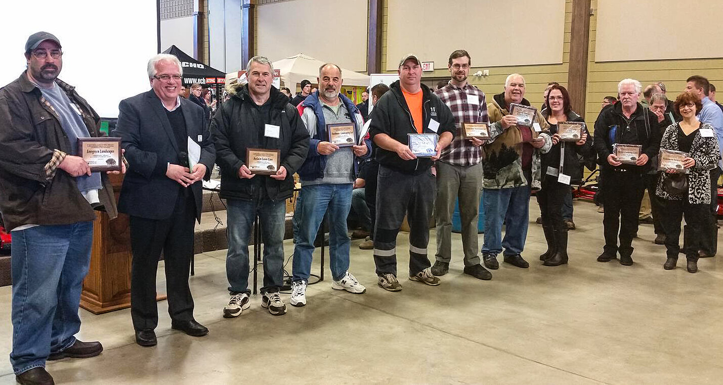 large group of people holding special plaques