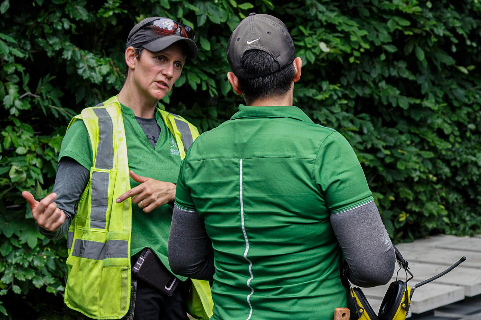 woman instructing a worker on the jobsite