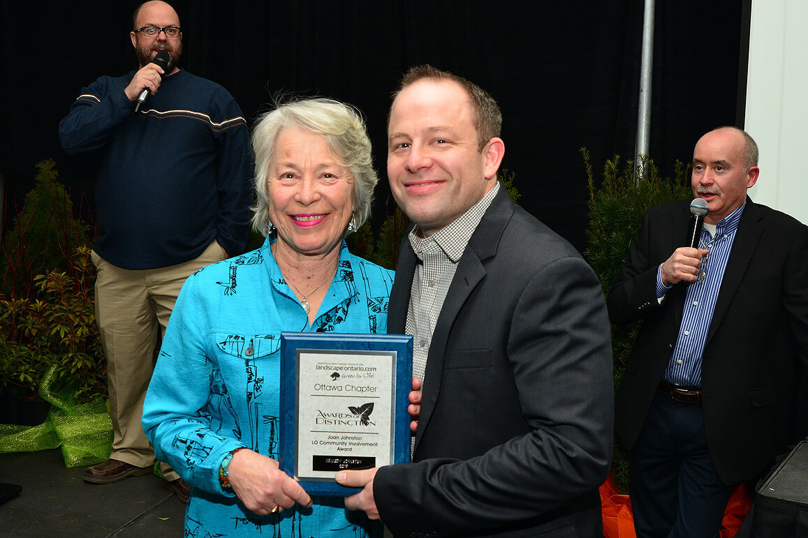 lady and man holding an award