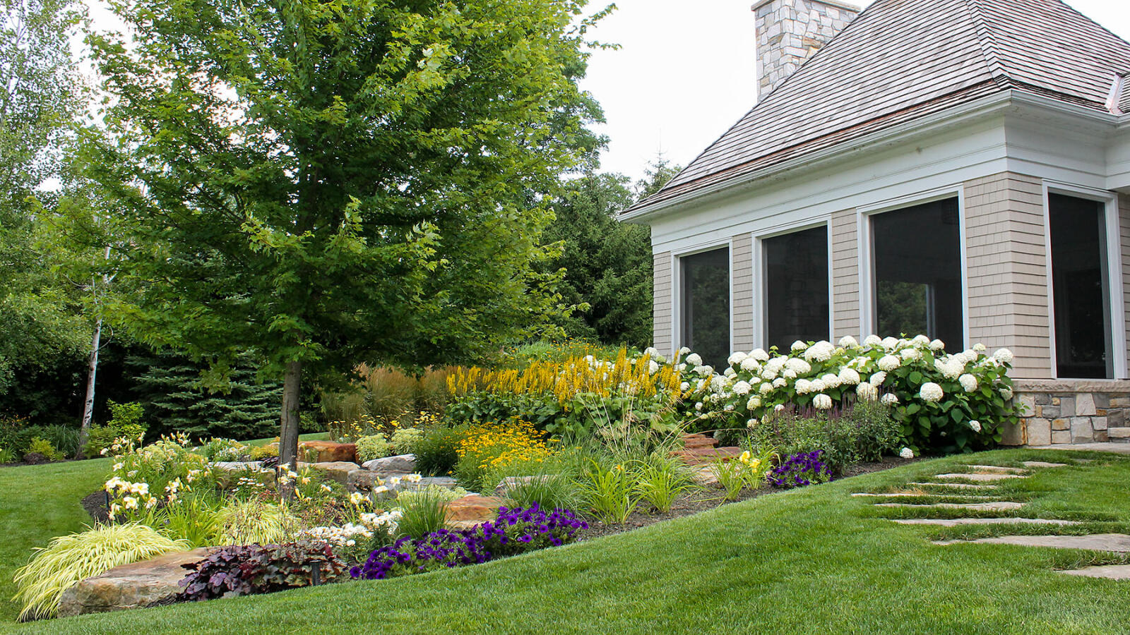 garden bed on a slope in front of a house