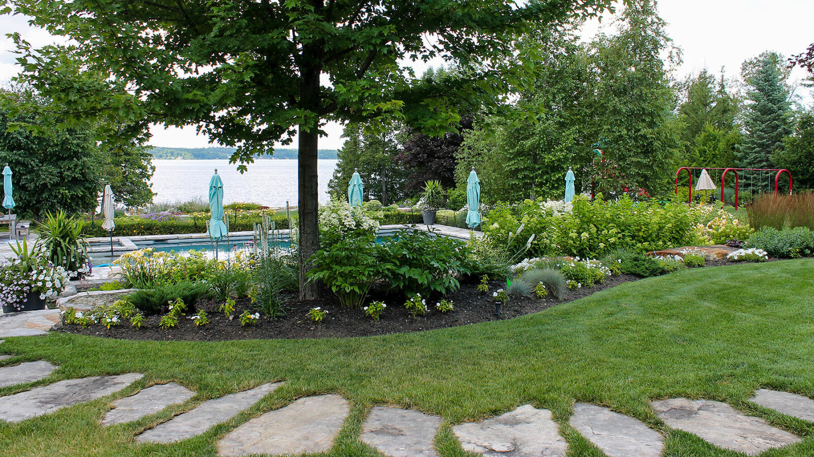 garden bed around a tree with lake in the distance
