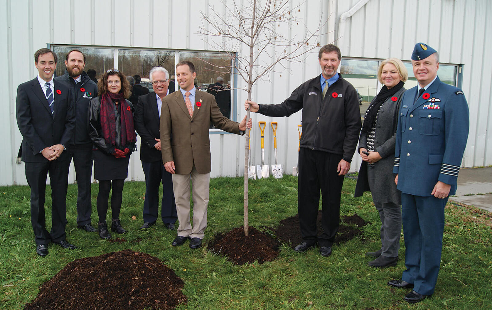 group of dignitaries planting a ceremonial tree