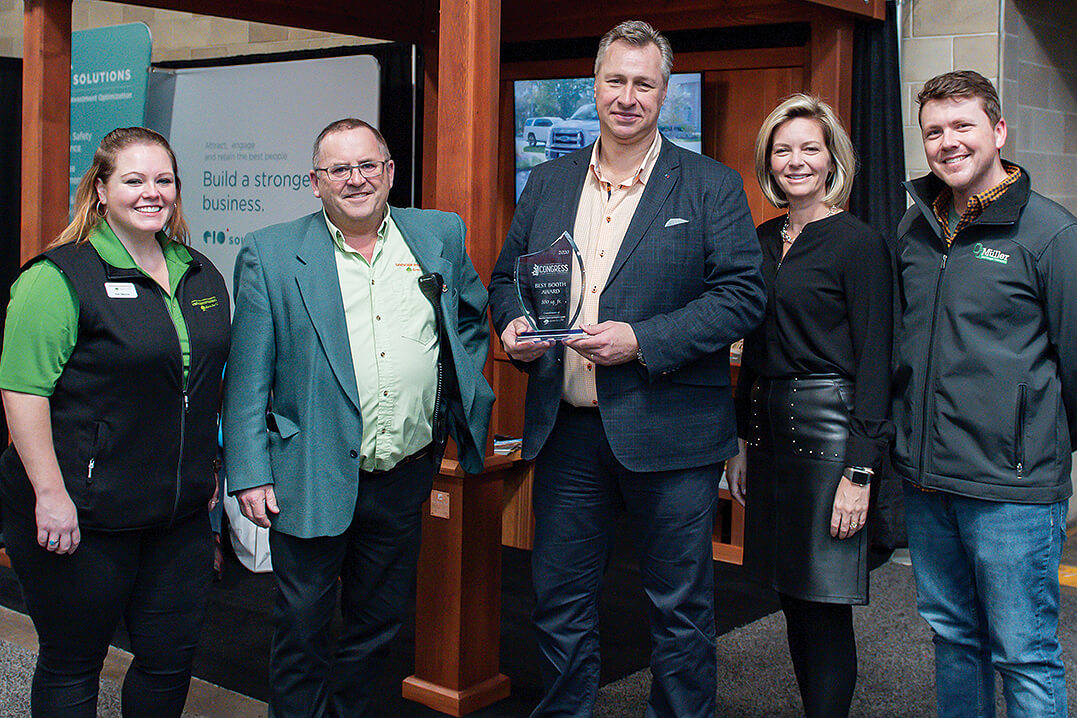 5 people with middle holding an award