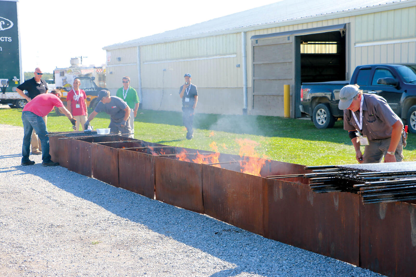 men cooking chicken on large barbecue