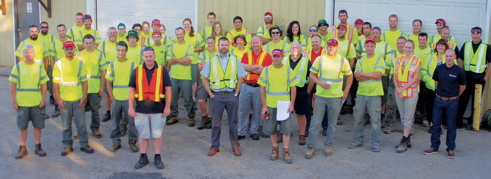 large group of workers outside their company building