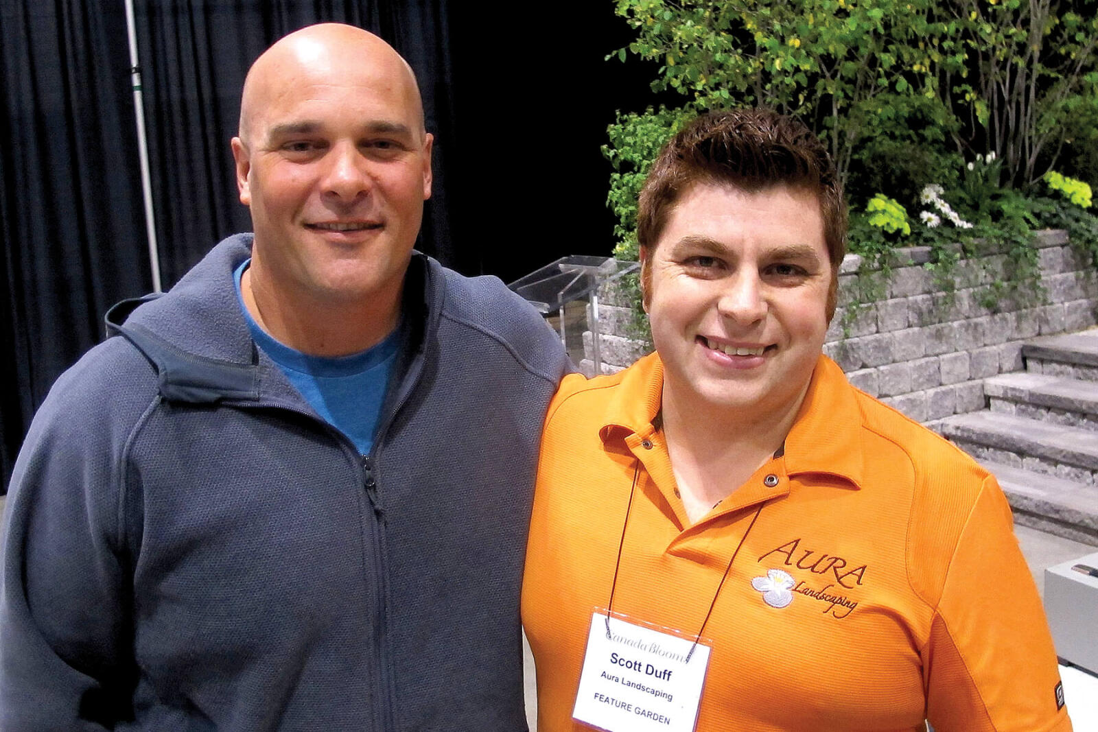 two men in front of a garden display