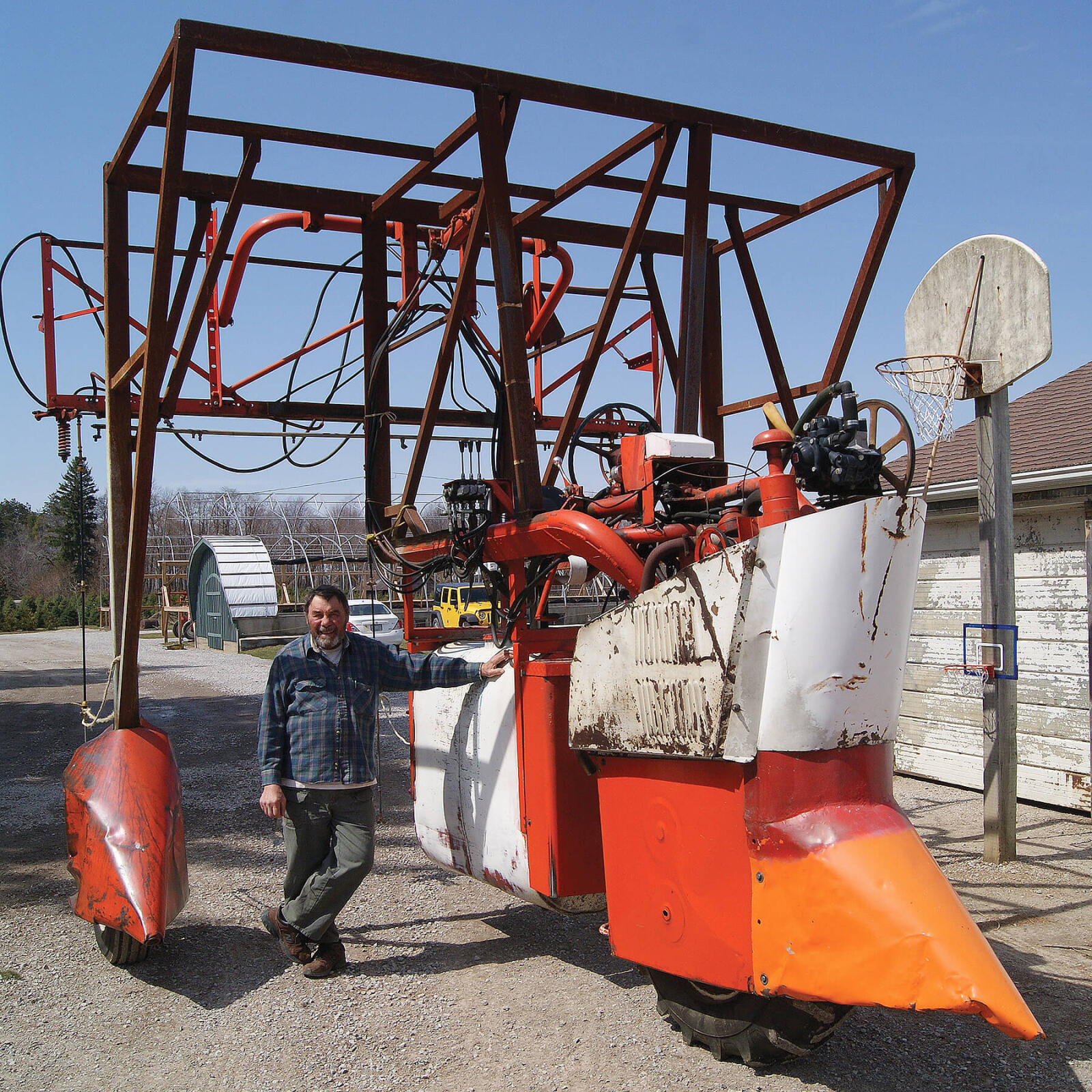 man standing beside a large machine