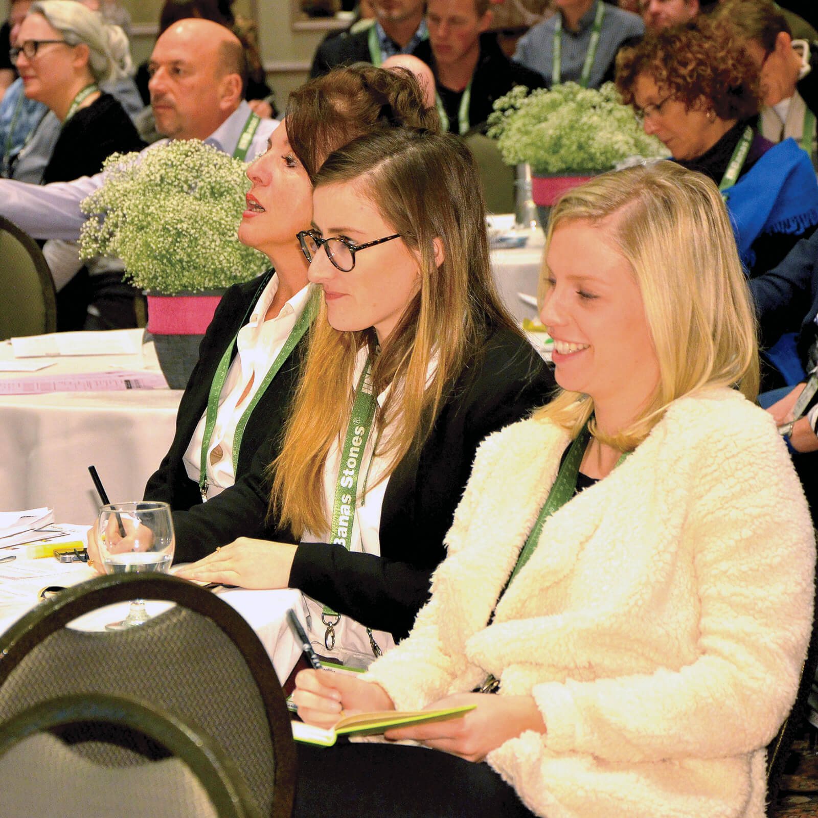 three women in the audience at a seminar