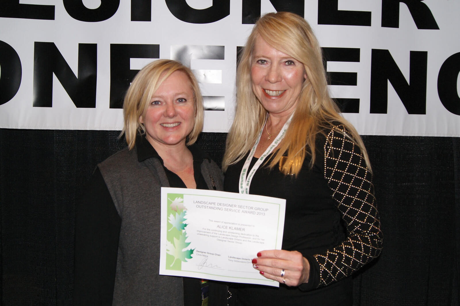 two women holding a certificate