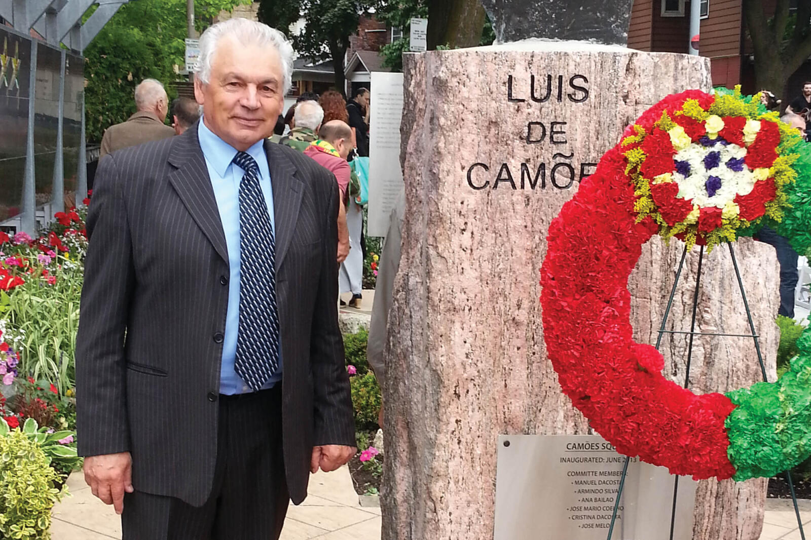 man standing next to a memorial