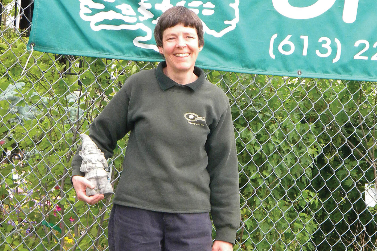 woman holding a small gardening gnome