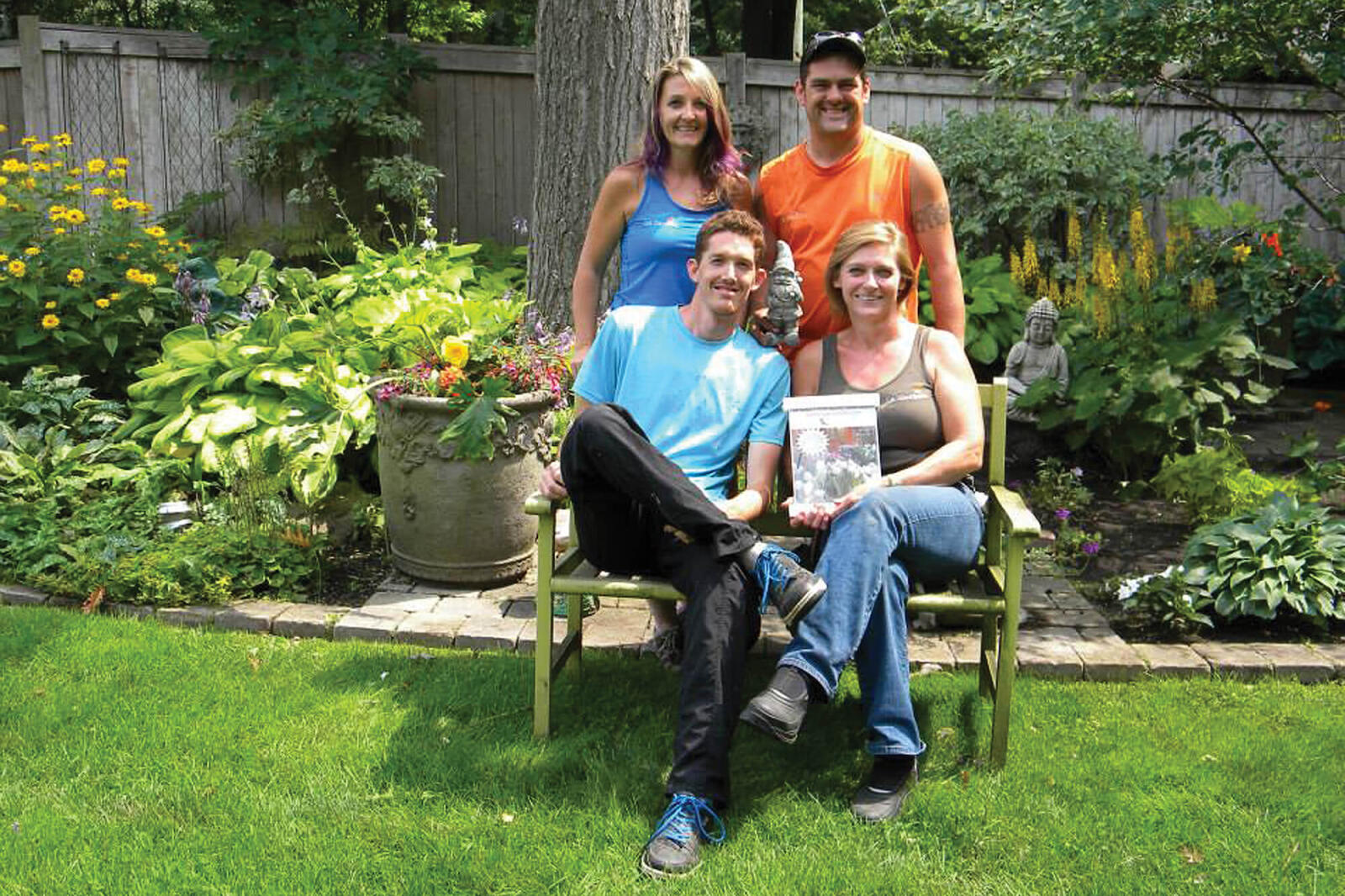 four people in a backyard