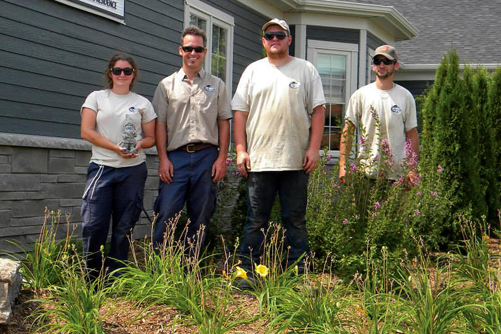 four people in a garden