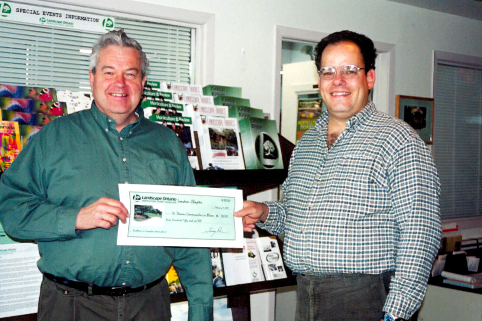 two men holding a cheque