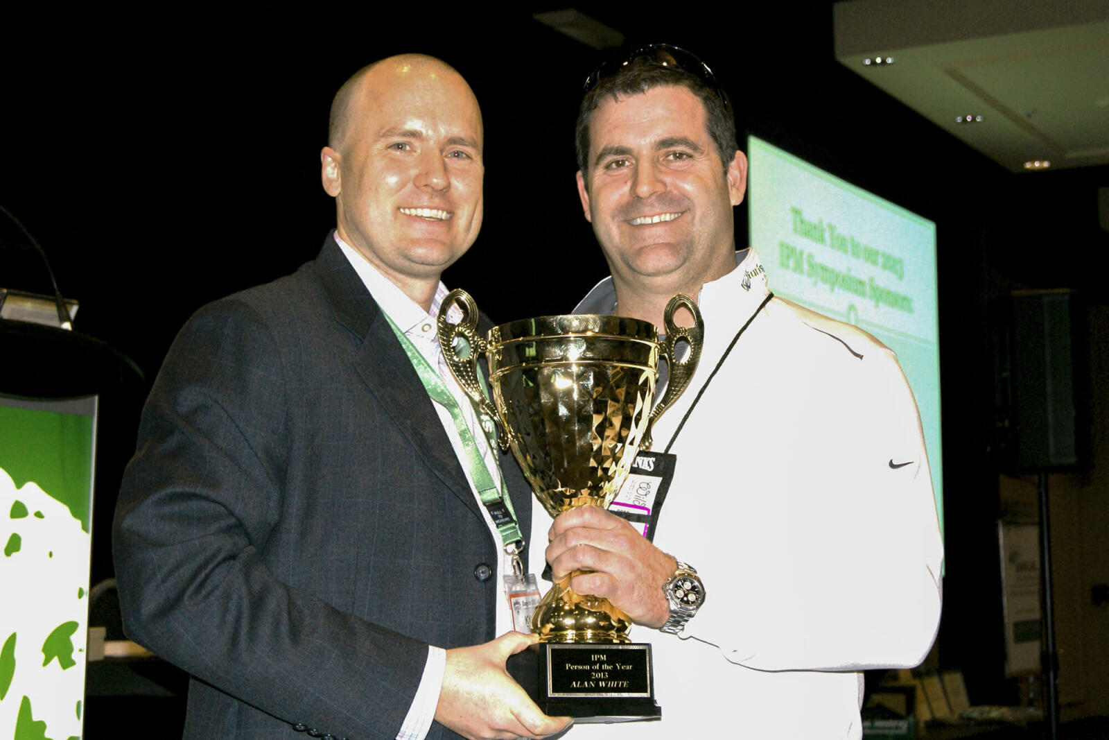 two men holding an award