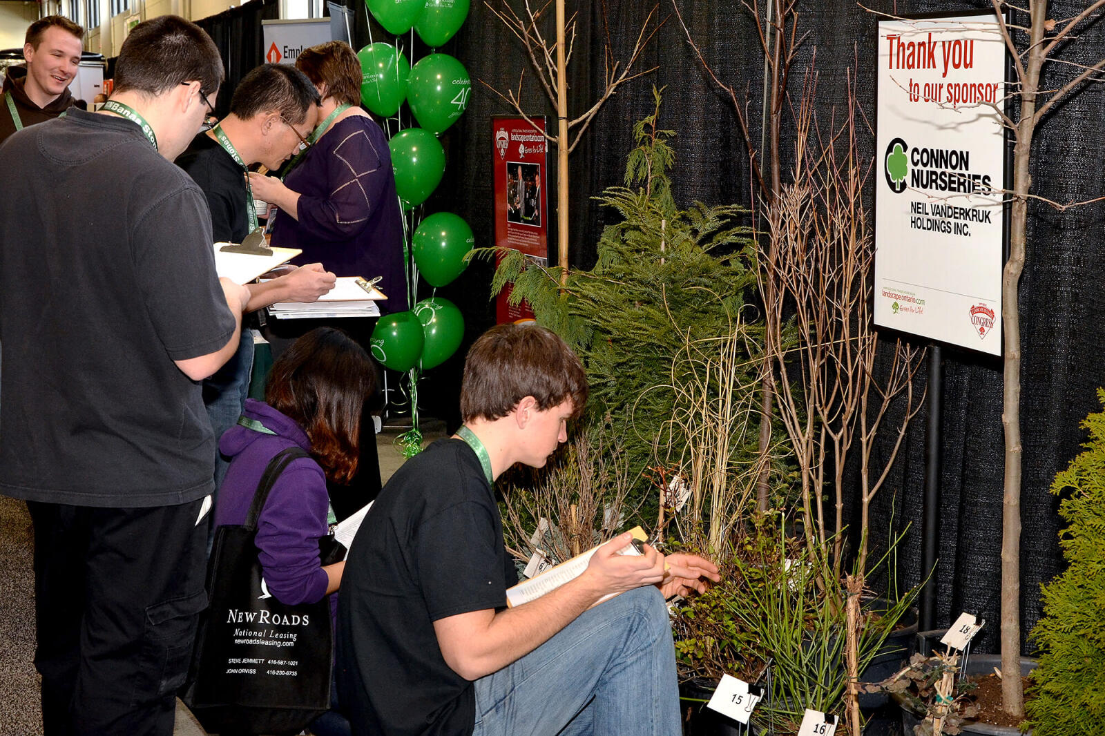 student looking at various types of plants