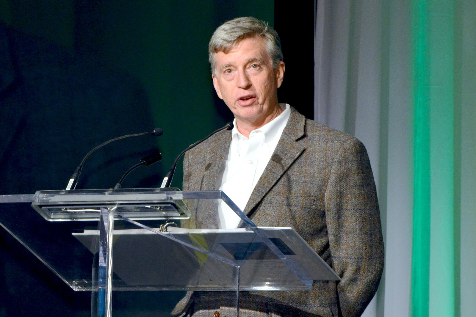 man speaking at a podium