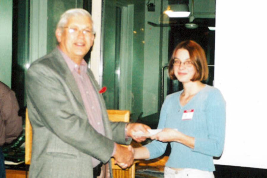 man giving an award to a young lady