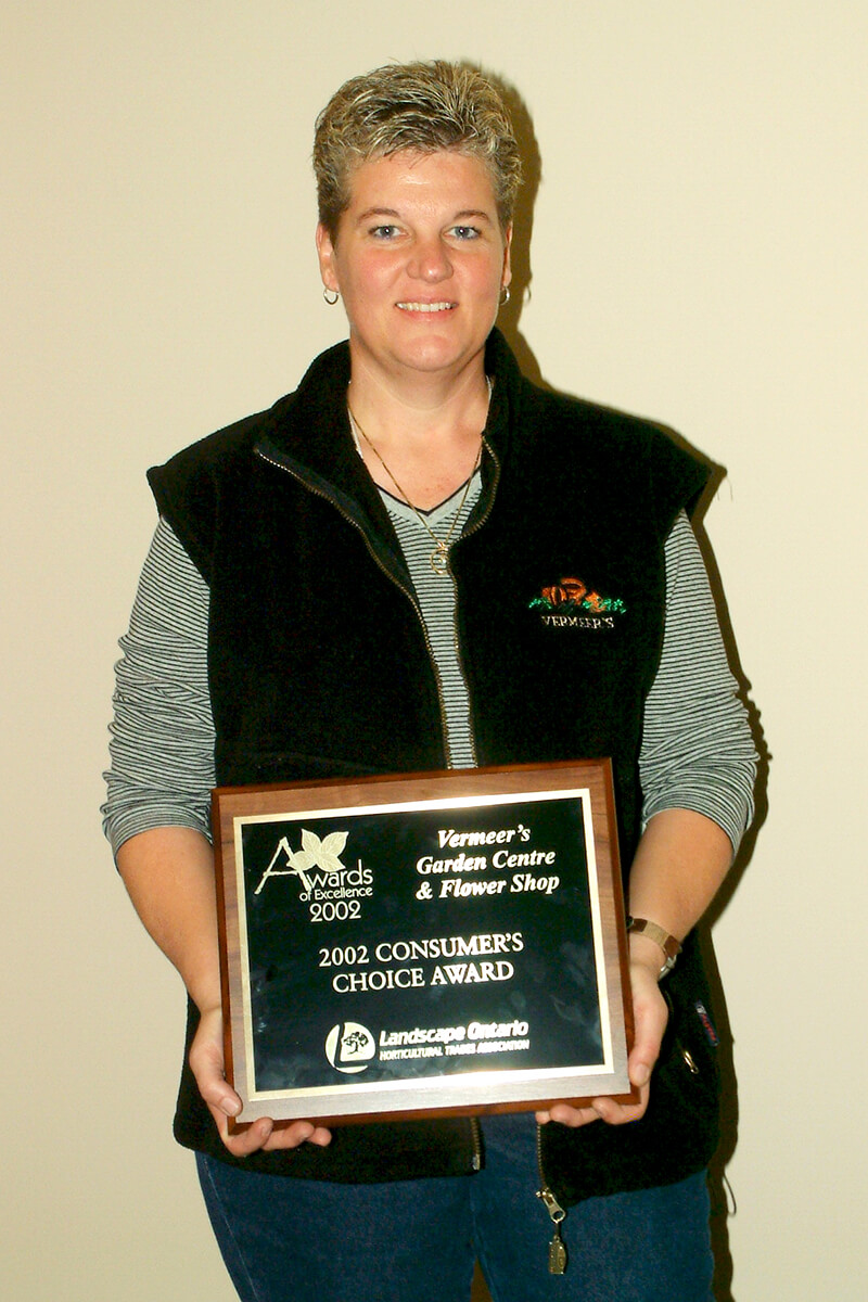 woman holding an award plaque