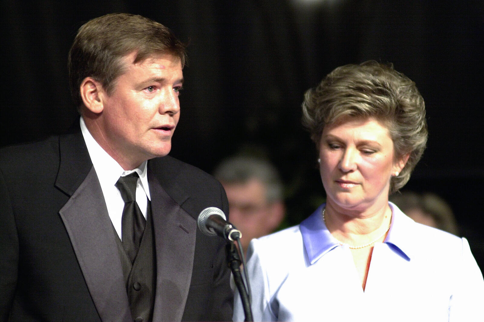 man and woman at a podium speaking