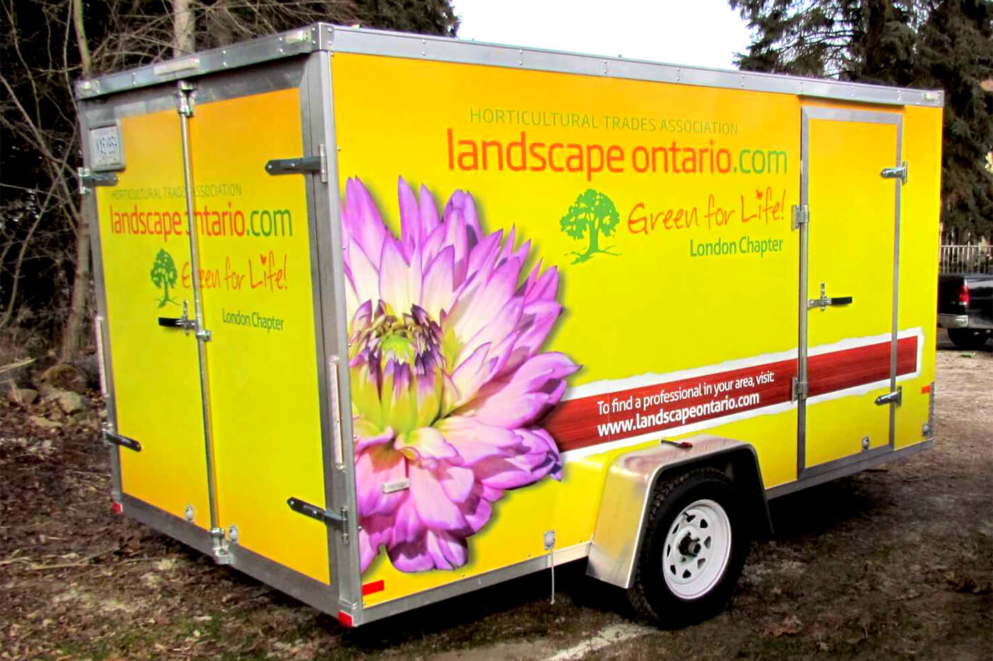 trailer with large flower and logo on the side