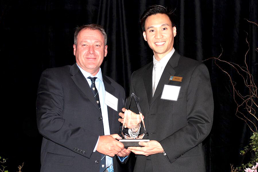 man presenting an award to another man