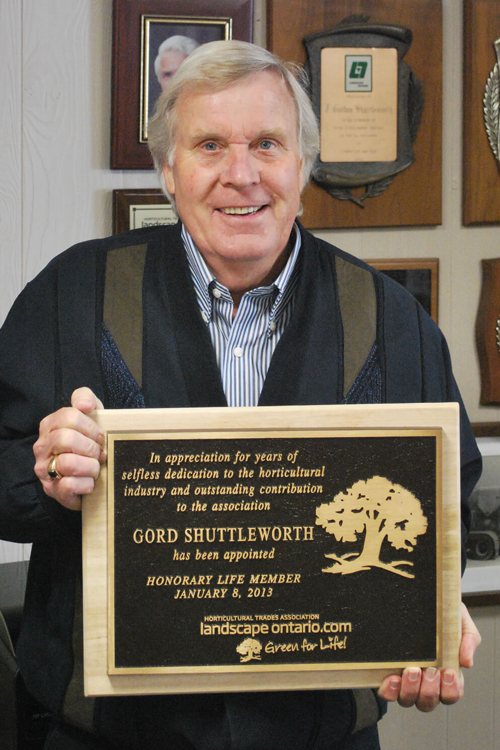 man proudly holding a plaque