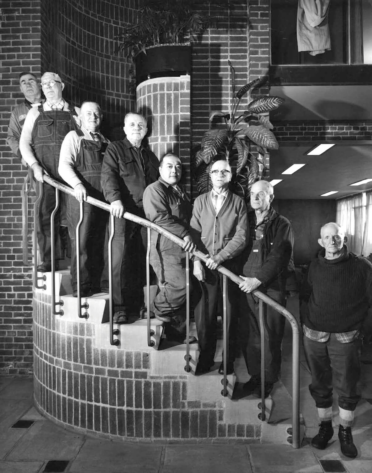 old black and white photo with a group of people on the stairs