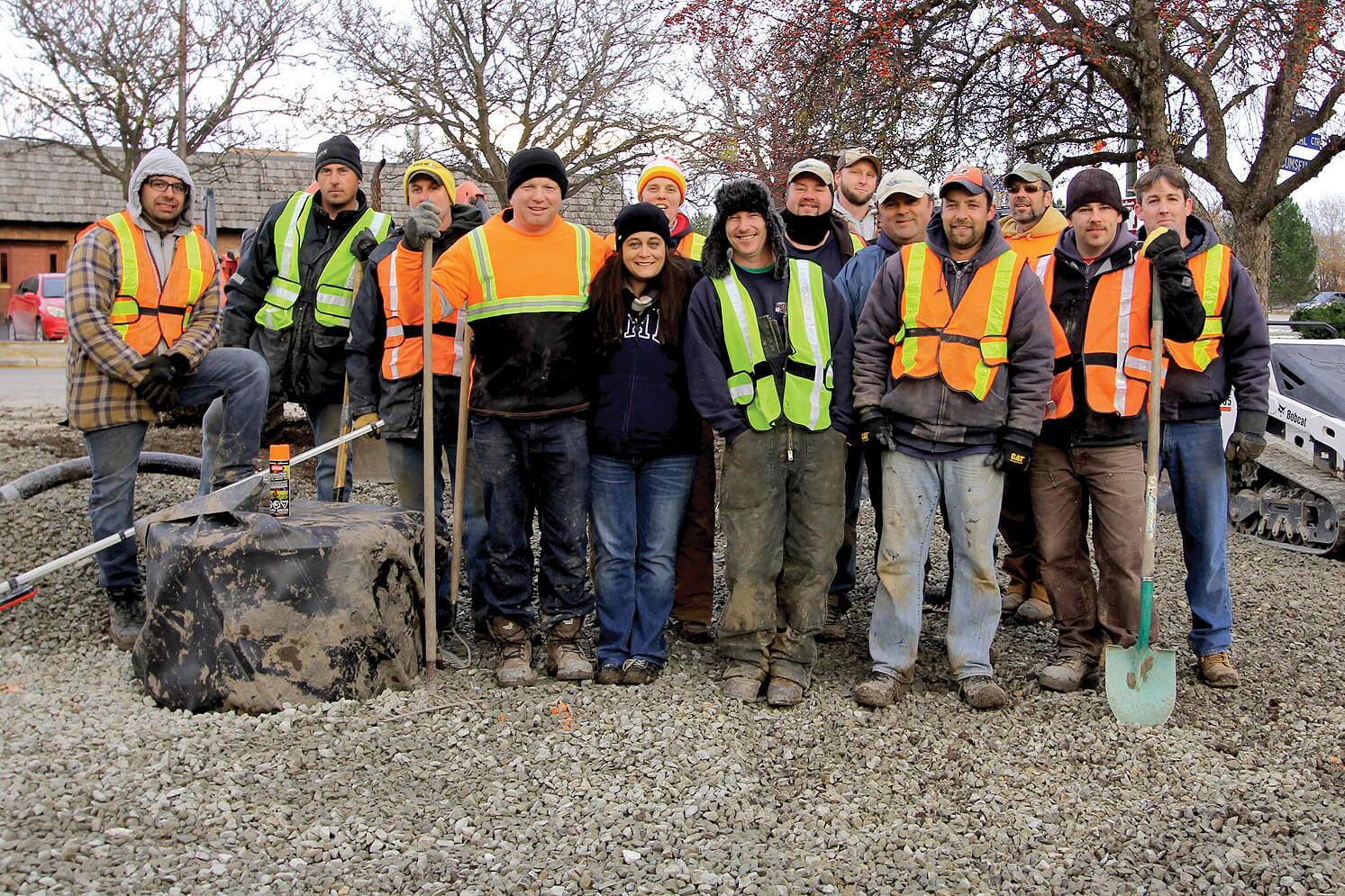 group of volunteer workers in construction clothes