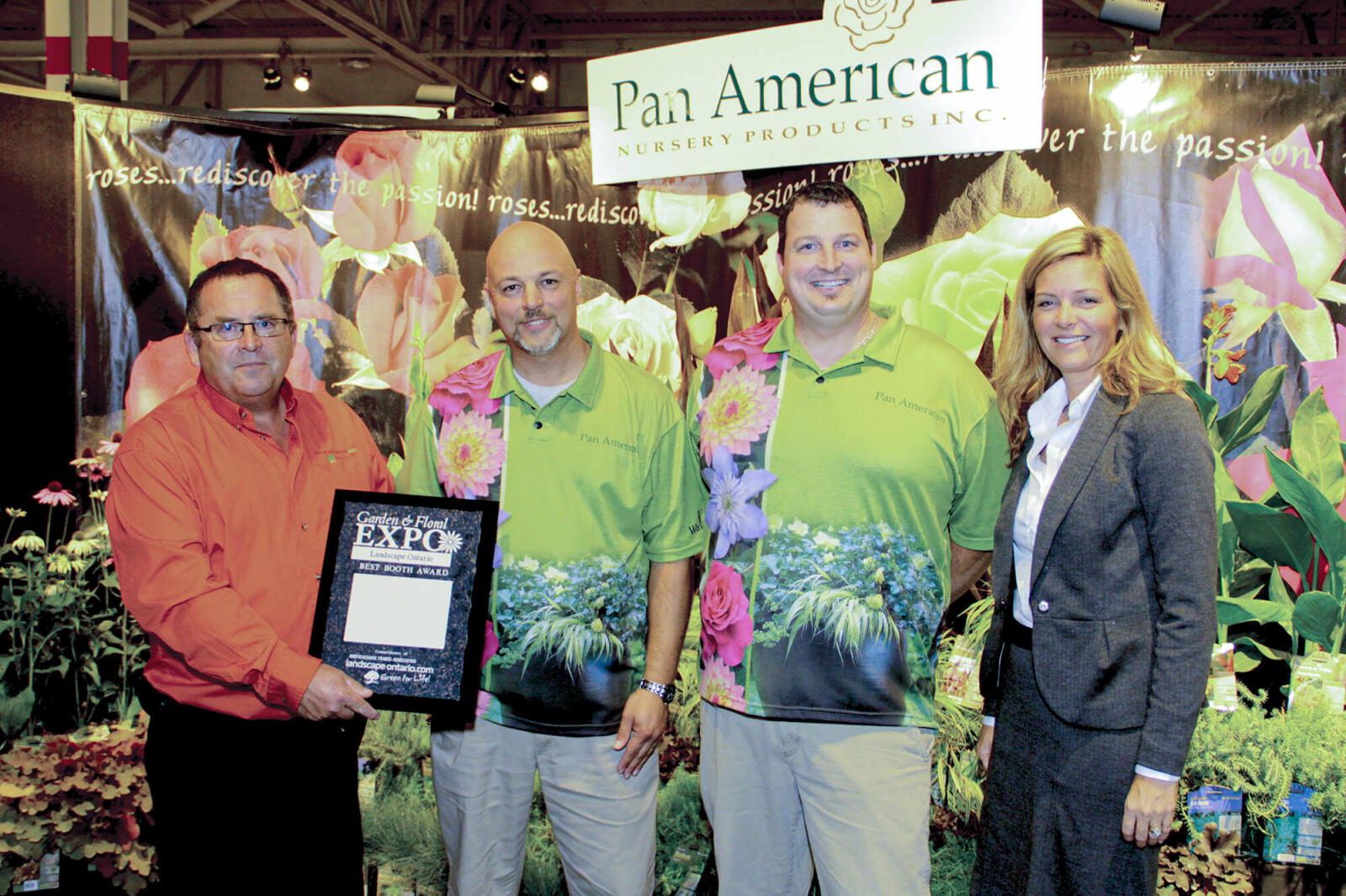 a man and woman presenting two men with an award