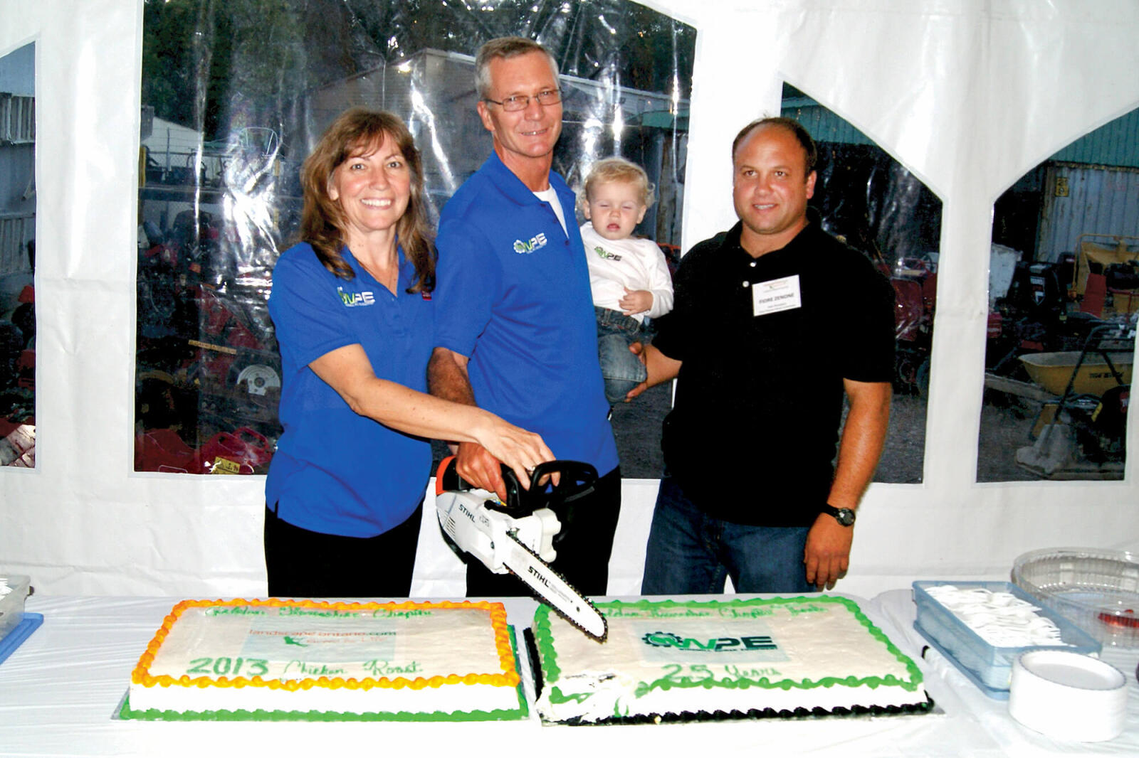 family cutting a large cake