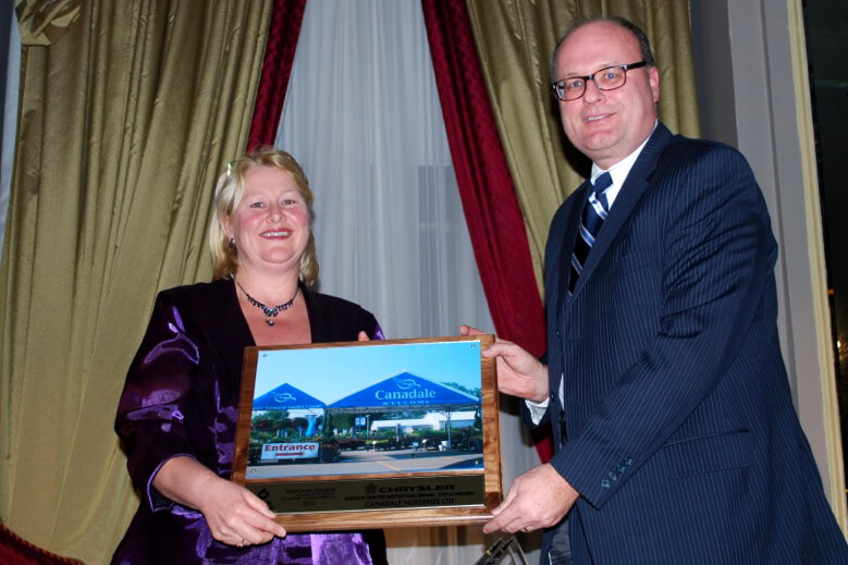 man and woman holding award