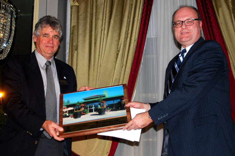 two men holding an award