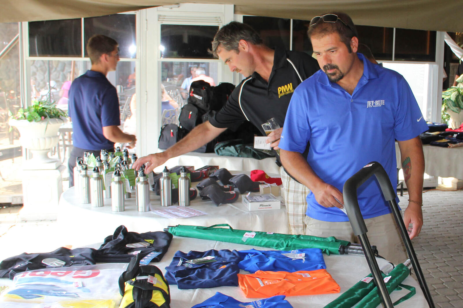 man looking over a prize table