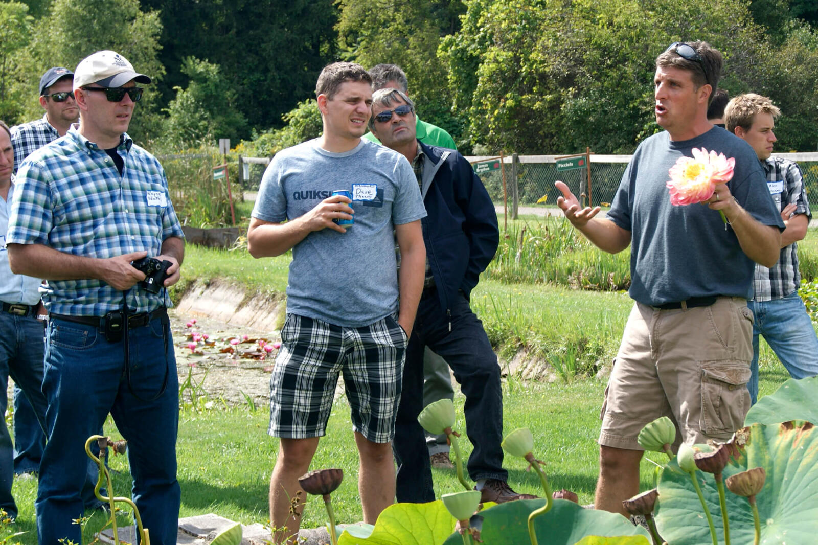 men standing in a nursery field